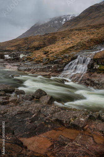 Fototapeta Naklejka Na Ścianę i Meble -  Stunning Winter landscape image of River Etive and Skyfall Etive Waterfalls in Scottish Highlands