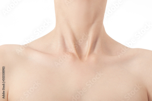 beautiful female slim neck with clavicle on black background, monochrome