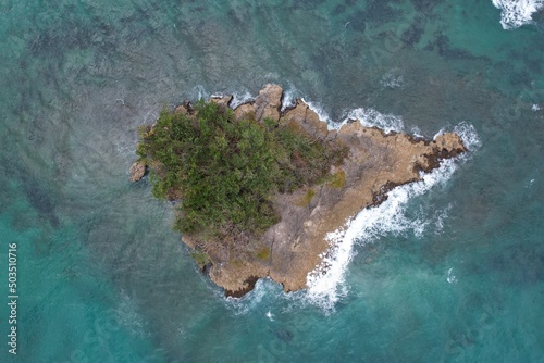 Island in the middle of the sea at Arroyo Salado Beach in Cabrera