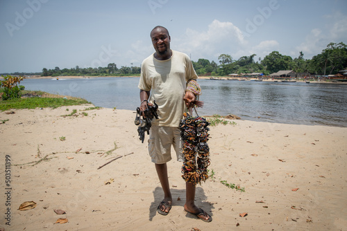 African bracelet peddler with all his handcrafted bracelets to sell