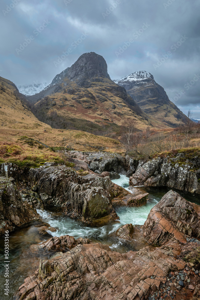 Gorgeous landscape image of vibrant River Coe flowing beneath snowcapped mountains in Scottish Highlands Gorgeous landscape image of vibrant River Coe flowing beneath snowcapped mountains in Scottish Highlands