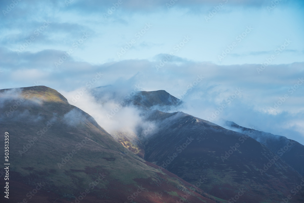 Stunning landscape image of Blencathra covered in low cloud fog and mist viewed from Walla Crag in Lake District