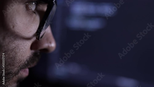 Face Of A Computer Scientist with glasses Close Up. Hacker or programmer. Low key light