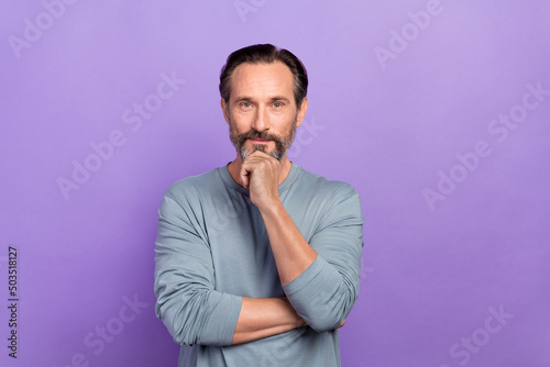 Photo of handsome good mood focused male brainstorming finding better solution isolated on violet color background