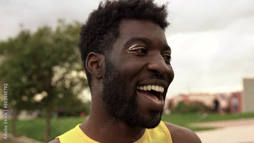 Young gay african man with make up smiling on camera