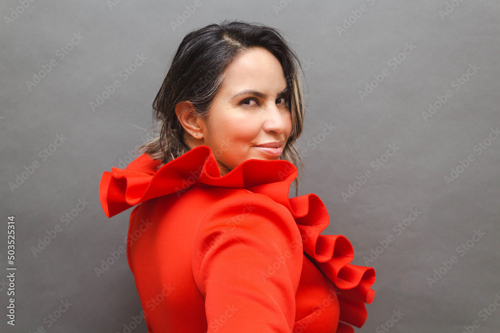 middle aged latin woman wearing elegant dress looking seductively at the camera middle aged latin woman wearing elegant dress looking seductively at the camera