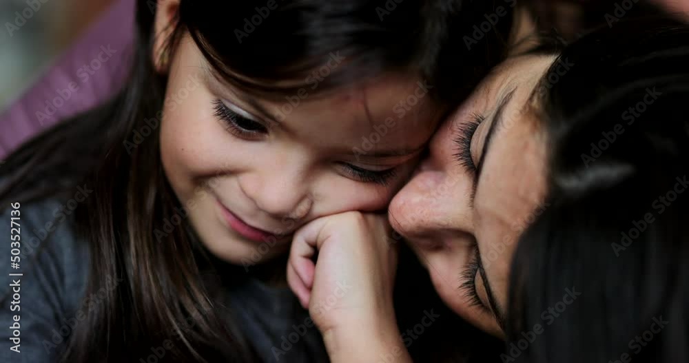 Mother kissing daughter family love and affection Mother kissing daughter family love and affection