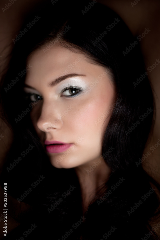 Dark and Moody Studio Portrait of a Strong Sexy Brunette Fashion Model with Hair and Makeup Dark and Moody Studio Portrait of a Strong Sexy Brunette Fashion Model with Hair and Makeup