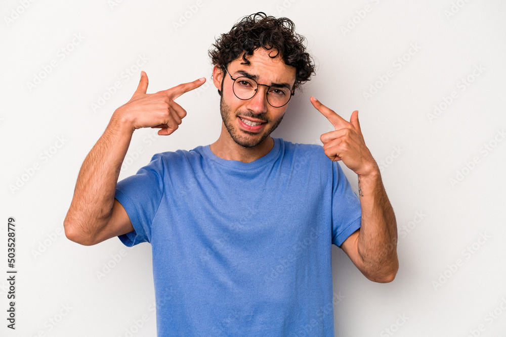 Young caucasian man isolated on white background showing a disappointment gesture with forefinger.