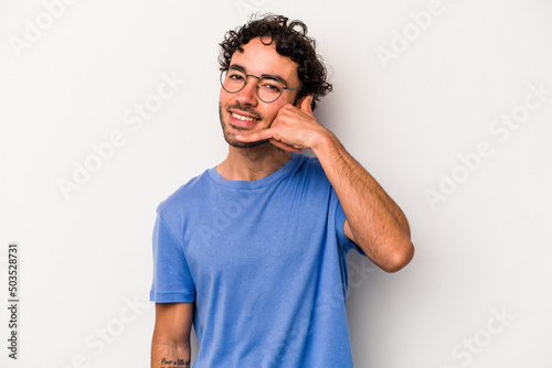 Young caucasian man isolated on white background showing a mobile phone call gesture with fingers.