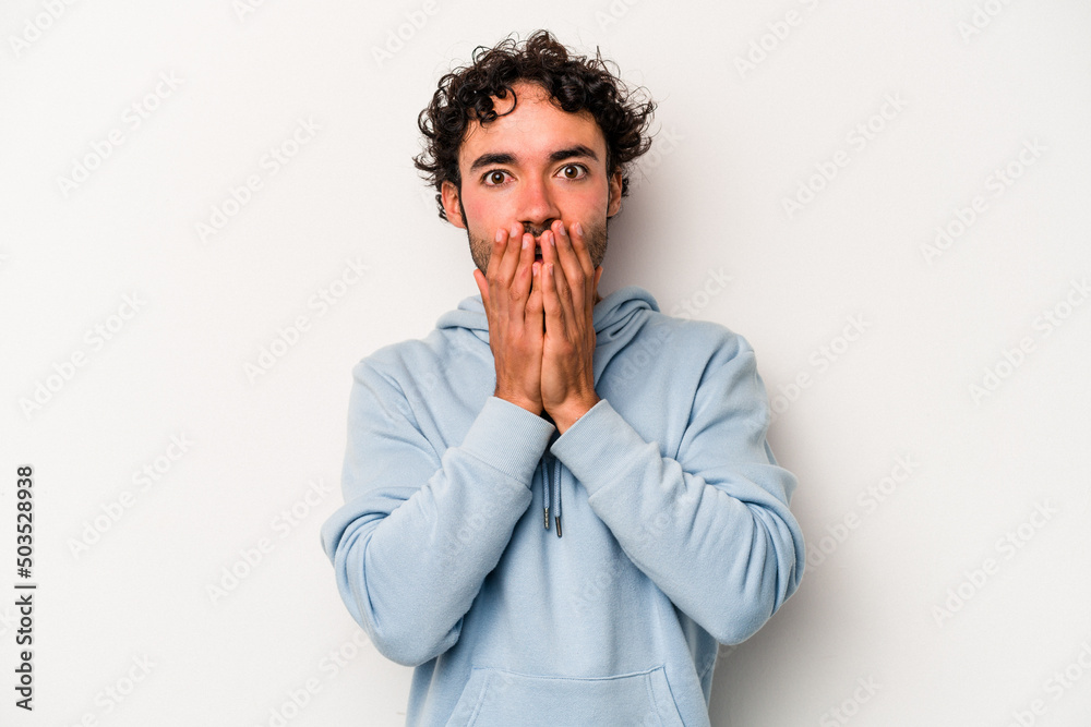Young caucasian man isolated on white background shocked covering mouth with hands. Young caucasian man isolated on white background shocked covering mouth with hands.