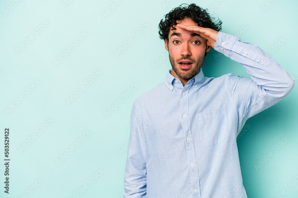 Young caucasian man isolated on white background shouts loud, keeps eyes opened and hands tense.