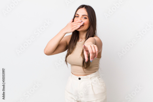 young pretty woman laughing at you, pointing to camera and making fun of or mocking you photo