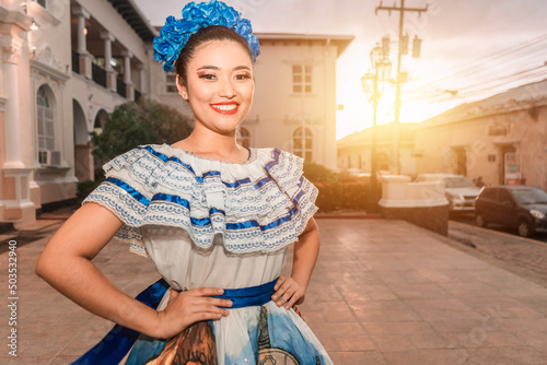 Traditional dance dancer from Nicaragua smiling and looking at the camera at sunset wearing the typical costume of Central America