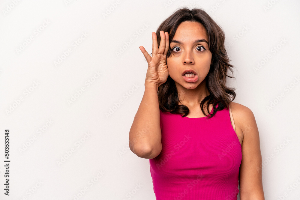 Young hispanic woman isolated on white background shouts loud, keeps eyes opened and hands tense. Young hispanic woman isolated on white background shouts loud, keeps eyes opened and hands tense.