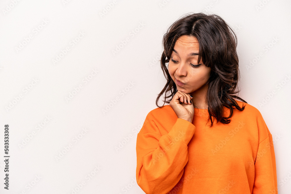 Young hispanic woman isolated on white background looking sideways with doubtful and skeptical expression. Young hispanic woman isolated on white background looking sideways with doubtful and skeptical expression.