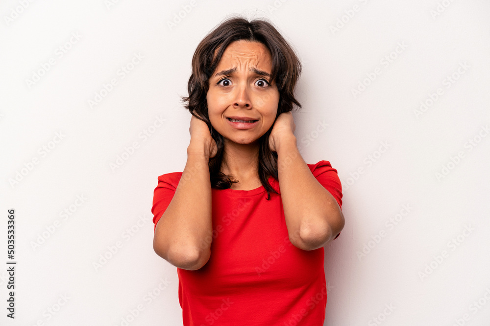 Young hispanic woman isolated on white background screaming with rage. Young hispanic woman isolated on white background screaming with rage.