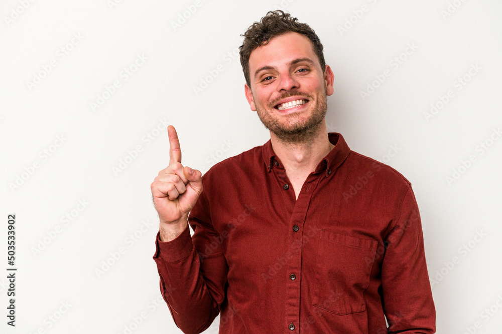 Young caucasian man isolated on white background showing number one with finger. Young caucasian man isolated on white background showing number one with finger.