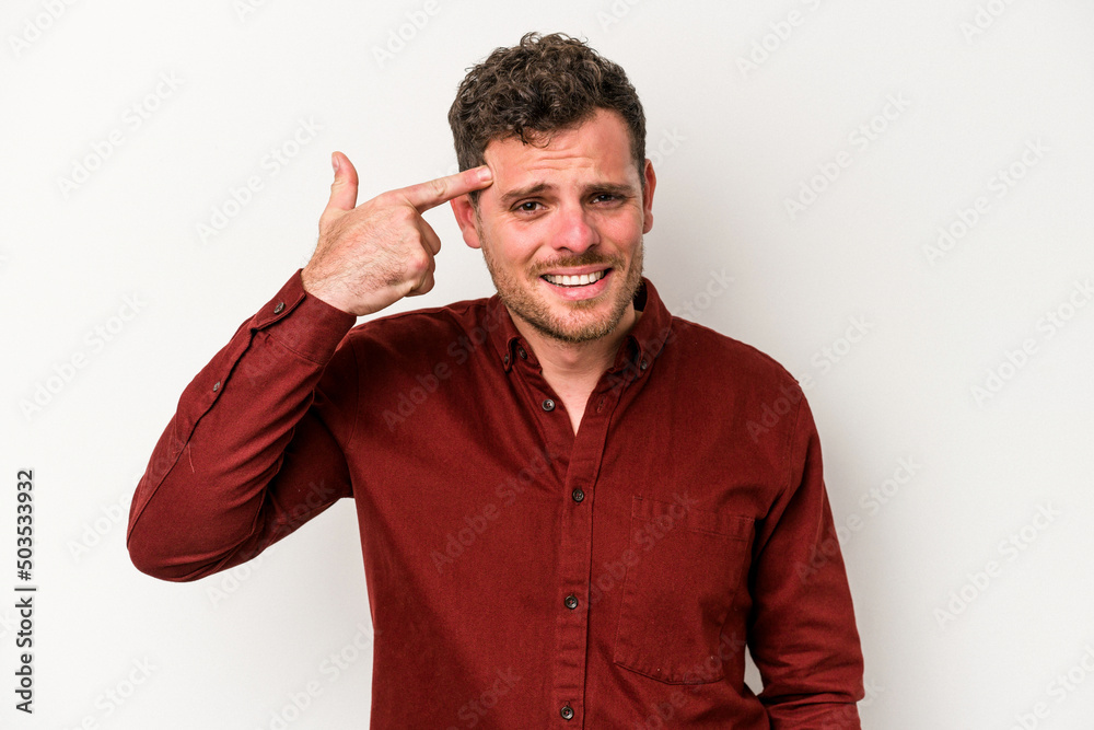 Young caucasian man isolated on white background showing a disappointment gesture with forefinger.