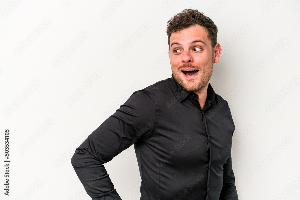 Young caucasian man isolated on white background looks aside smiling, cheerful and pleasant. Young caucasian man isolated on white background looks aside smiling, cheerful and pleasant.