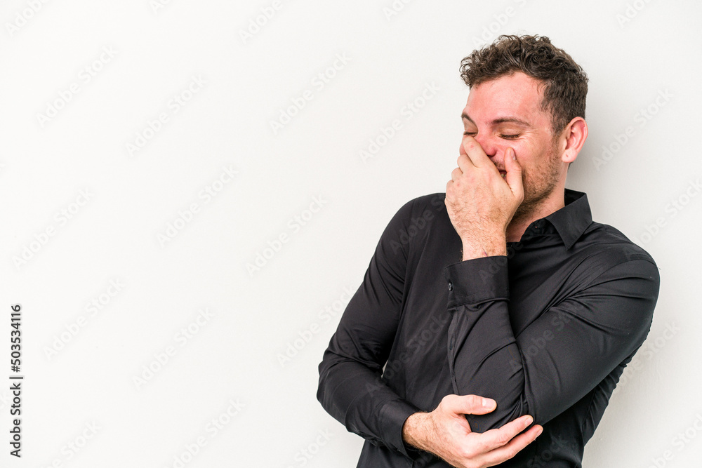 Young caucasian man isolated on white background laughing happy, carefree, natural emotion.