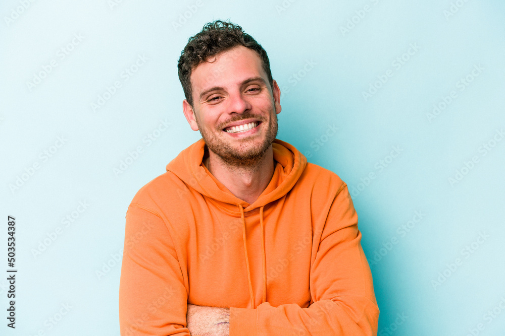Fototapeta premium Young caucasian man isolated on blue background laughing and having fun.