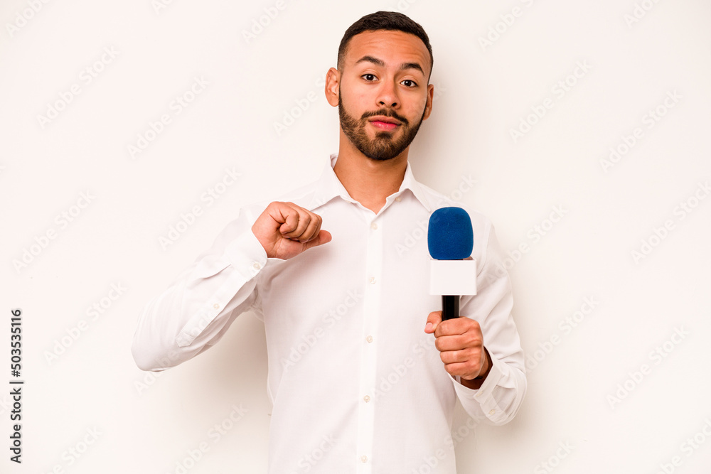 Young hispanic TV presenter isolated on blue background feels proud and self confident, example to follow. Young hispanic TV presenter isolated on blue background feels proud and self confident, example to follow.