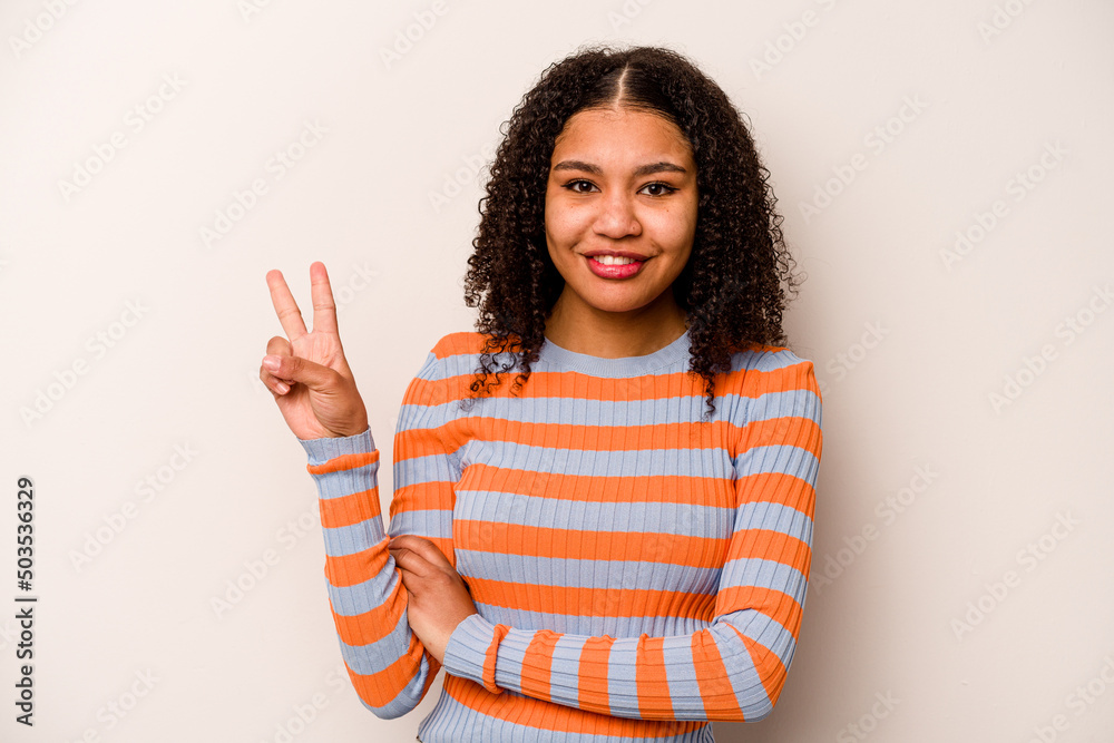 Young African American woman isolated on white background showing number two with fingers. Young African American woman isolated on white background showing number two with fingers.