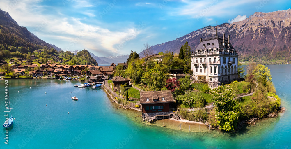 Stunning idylic nature scenery of lake Brienz with turquoise waters. Switzerland, Bern canton. Iseltwald village surrounded turquoise waters ,aereal view