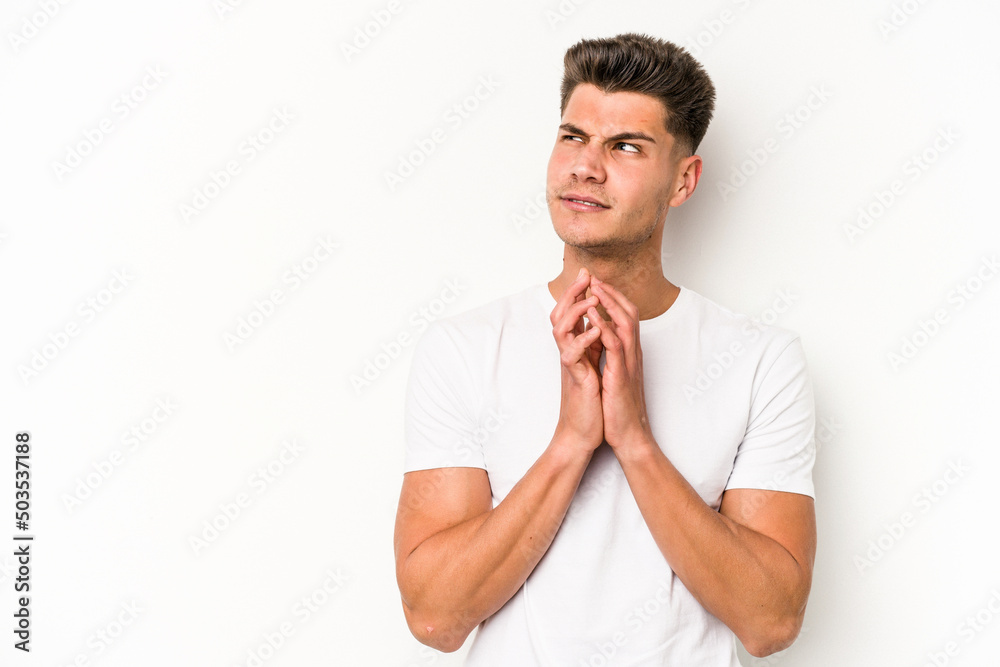 Young caucasian man isolated on white background making up plan in mind, setting up an idea. Young caucasian man isolated on white background making up plan in mind, setting up an idea.
