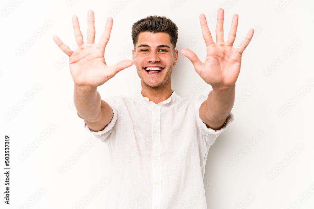 Young caucasian man isolated on white background showing number ten with hands. Young caucasian man isolated on white background showing number ten with hands.