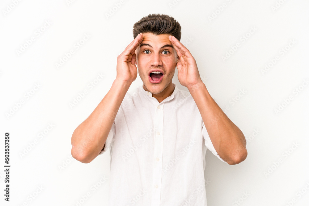 Young caucasian man isolated on white background receiving a pleasant surprise, excited and raising hands. Young caucasian man isolated on white background receiving a pleasant surprise, excited and raising hands.