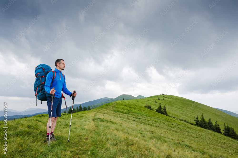 Hiking man walking in the mountains