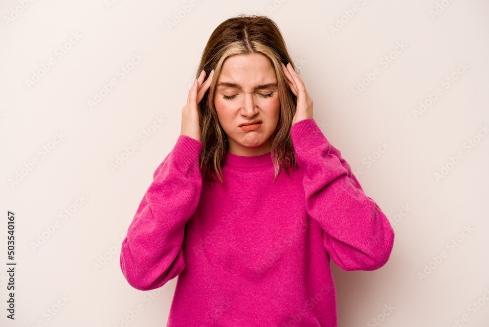 Young caucasian woman isolated on white background having a head ache, touching front of the face. Young caucasian woman isolated on white background having a head ache, touching front of the face.