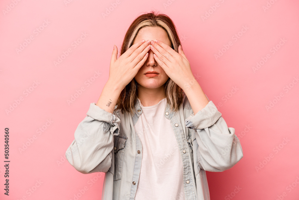 Young caucasian woman isolated on pink background afraid covering eyes with hands. Young caucasian woman isolated on pink background afraid covering eyes with hands.