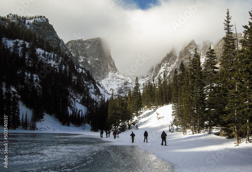 snowshoers hiking along Dream Lake toward Hallett Peak, Rocky Mountain National Park photo