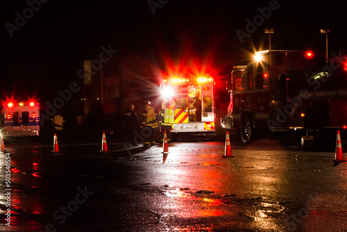 Critical collision response by firefighters and medics on a wet night