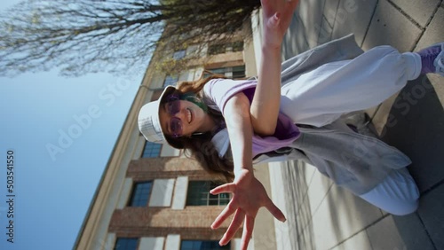 Closeup girl staring at camera. Portrait of charming female person dancing on the street