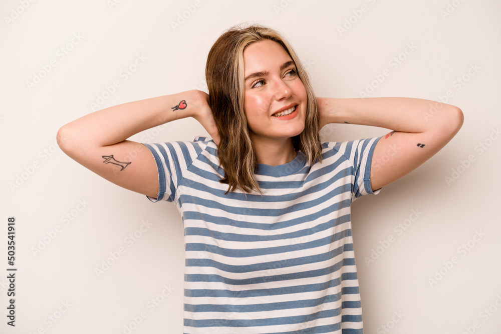 Young caucasian woman isolated on white background feeling confident, with hands behind the head. Young caucasian woman isolated on white background feeling confident, with hands behind the head.