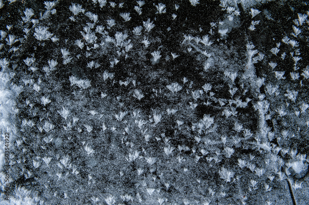 Texture of frozen ice surface with snow