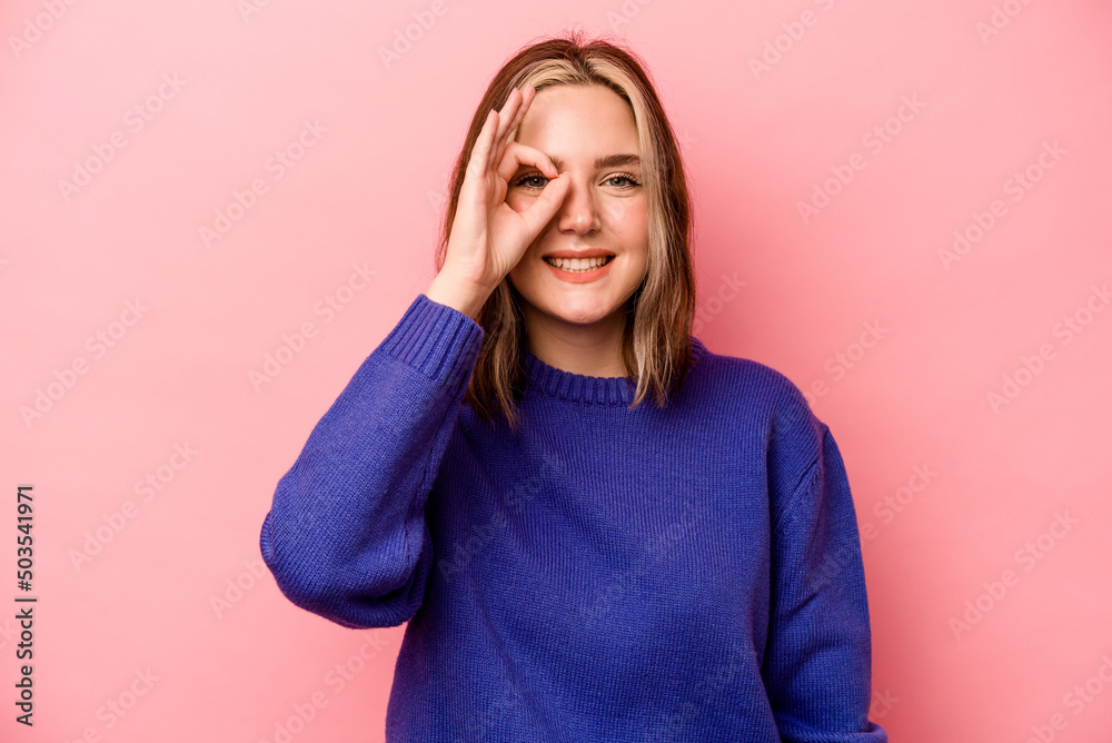 Young caucasian woman isolated on pink background excited keeping ok gesture on eye. Young caucasian woman isolated on pink background excited keeping ok gesture on eye.