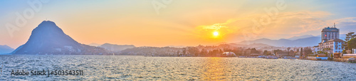 The sunset above Lugano Lake, Mount San Salvatore and central part of Lugano city, Switzerland photo