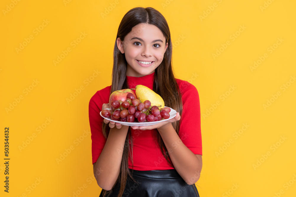 glad girl hold fresh fruit plate on yellow background glad girl hold fresh fruit plate on yellow background