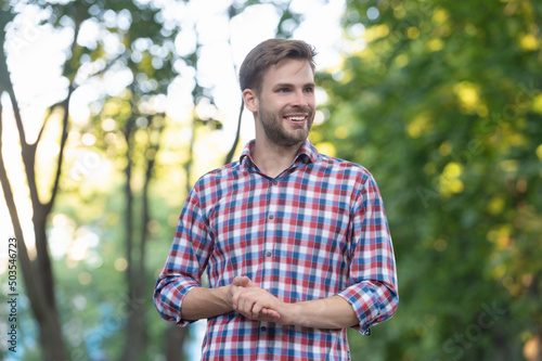 Fototapeta Naklejka Na Ścianę i Meble -  happy young man in checkered shirt outdoor