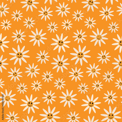 Cute smiling white daisy flowers seamless pattern on orange background in retro style. For textile, baby shower and gift wrapping paper  photo