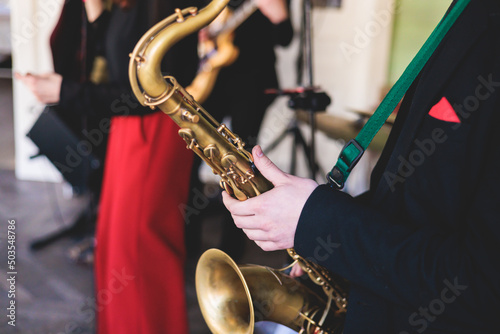 Photography Concert view of saxophonist, saxophone sax player with vocalist and musical duri