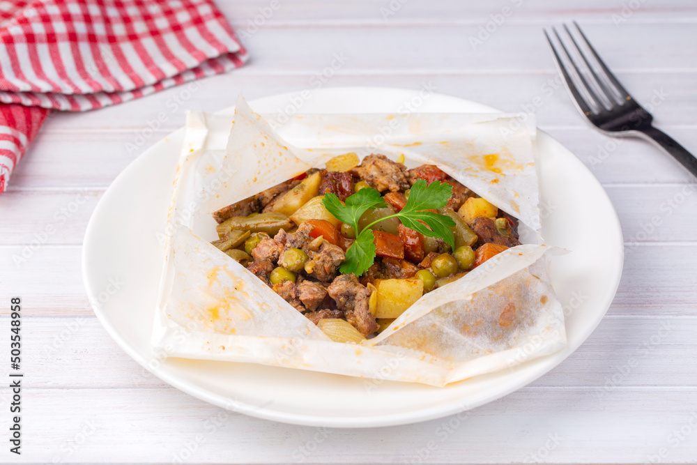 Traditional Turkish food; Meat with vegetables wrapped in greaseproof paper, kebab (Turkish name; Sebzeli kagit kebabi) Traditional Turkish food; Meat with vegetables wrapped in greaseproof paper, kebab (Turkish name; Sebzeli kagit kebabi)