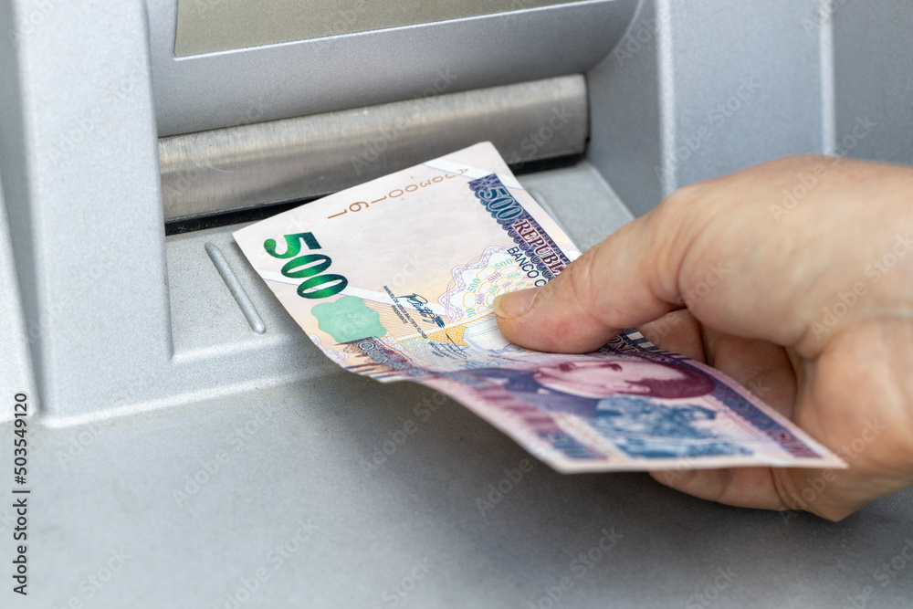 Woman chooses 500 Lempira from ATM, Honduran currency, Highest denomination, Economic and financial concept