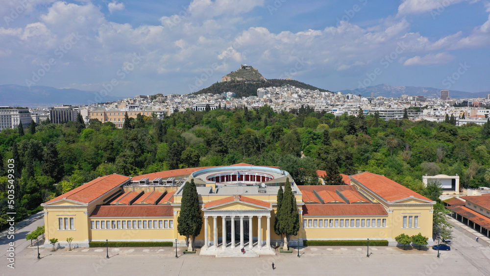 Aerial photo taken by drone of iconic public Zappeio hall used for events and lycabettus hill at the background , Athens historic centre, Attica, Greece
