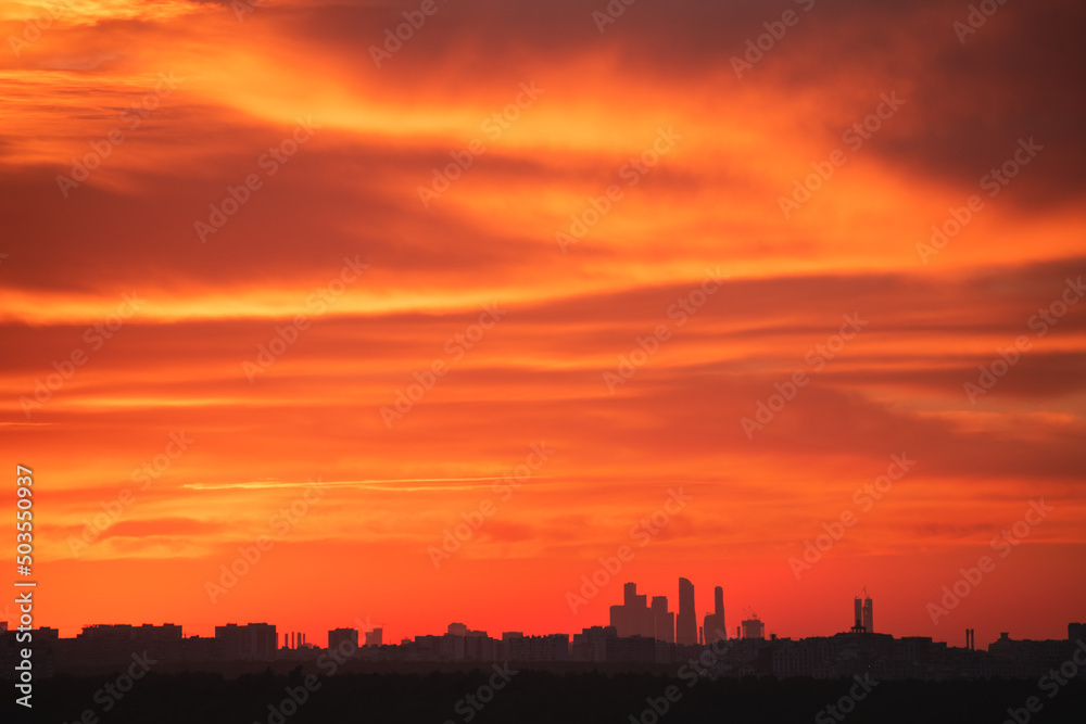 Skyline of Moscow city at sunset, Russia. Cityscape abstract background. Red sky with clouds over the city, panoramic view.  Moscow, Russia.